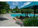 Community pool with clear water and lounge chairs, set in a beautiful landscape at 328 Wickley Way, Woodstock, GA 30188