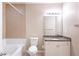 Bathroom with granite countertop, bathtub, and tile surround at 10 Perimeter Summit Ne Blvd # 3204, Atlanta, GA 30319