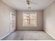 Bright bedroom featuring a window, ceiling fan and an access door to a balcony at 10 Perimeter Summit Ne Blvd # 3204, Atlanta, GA 30319