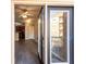 View from the balcony into the living room with ceiling fan, wood floors, and access to the kitchen at 10 Perimeter Summit Ne Blvd # 3204, Atlanta, GA 30319