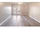 Light-filled living room with doors to balcony and stylish hardwood flooring at 10 Perimeter Summit Ne Blvd # 3204, Atlanta, GA 30319
