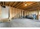 Unfinished basement ready for customization with exposed wood beams and concrete floor at 1872 Commons Nw Pl, Atlanta, GA 30318