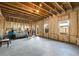 Unfinished basement ready for customization with exposed wood beams and concrete floor at 1872 Commons Nw Pl, Atlanta, GA 30318