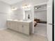 Bright bathroom with double sink vanity, tiled floor and access to main bedroom at 1872 Commons Nw Pl, Atlanta, GA 30318