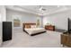 Spacious main bedroom features a tray ceiling, ceiling fan, large windows and carpeted floor at 1872 Commons Nw Pl, Atlanta, GA 30318