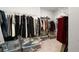 Walk-in closet featuring hanging clothes, wire shelves, and plastic storage bins at 1872 Commons Nw Pl, Atlanta, GA 30318