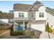 Charming two-story home with stone and vinyl siding, a covered porch, and a two-car garage at 1872 Commons Nw Pl, Atlanta, GA 30318