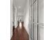 Inviting hallway features hardwood floors, neutral paint, and a clear view to the back of the home at 1872 Commons Nw Pl, Atlanta, GA 30318