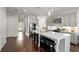 Well-appointed kitchen featuring stainless appliances, ample counter space, an island with bar seating, and modern lighting fixtures at 1872 Commons Nw Pl, Atlanta, GA 30318