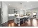 Contemporary kitchen with white cabinets, stainless appliances, a large island with seating, and modern pendant lights at 1872 Commons Nw Pl, Atlanta, GA 30318
