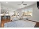 Open-concept living room with hardwood floors, large windows, kitchen bar and comfortable couch at 1872 Commons Nw Pl, Atlanta, GA 30318