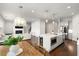 Open-concept kitchen and living room with hardwood floors and a cozy fireplace at 1872 Commons Nw Pl, Atlanta, GA 30318