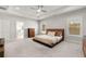 Large main bedroom with a ceiling fan, en suite bathroom, and wooden bed frame at 1872 Commons Nw Pl, Atlanta, GA 30318