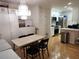 Combined dining area with modern lighting fixtures, stainless steel appliances, and hardwood floors at 2201 Pine Heights Ne Dr, Atlanta, GA 30324