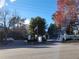 Community entrance with sign, flag, and mature trees, enhancing the property's appeal at 2201 Pine Heights Ne Dr, Atlanta, GA 30324