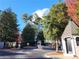 Elegant gated entrance with a water fountain feature surrounded by lush greenery and mature trees at 2201 Pine Heights Ne Dr, Atlanta, GA 30324