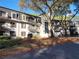 Well-maintained building exterior with balconies, mature trees, and black window shutters at 2201 Pine Heights Ne Dr, Atlanta, GA 30324