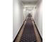 Long hallway with patterned carpet, recessed lighting, and access to various rooms, offering a sense of elegance at 2201 Pine Heights Ne Dr, Atlanta, GA 30324