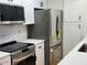 Modern kitchen with stainless steel appliances, white cabinets, quartz countertops, and subway tile backsplash at 2201 Pine Heights Ne Dr, Atlanta, GA 30324