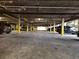 Well-lit parking garage with concrete floor and painted support beams at 2201 Pine Heights Ne Dr, Atlanta, GA 30324