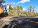 Outdoor tennis courts surrounded by lush trees and foliage in a peaceful setting at 2201 Pine Heights Ne Dr, Atlanta, GA 30324
