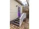 Back door entrance featuring a purple door with steps and a white railing at 357 Glenwood Se Ave, Atlanta, GA 30312