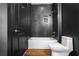 Modern bathroom with dark tile, gold fixtures, and a soaking tub at 2626 Peachtree Nw Rd # 1102, Atlanta, GA 30305