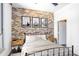 Cozy bedroom with a bed, bedside tables and exposed brick wall at 2626 Peachtree Nw Rd # 1102, Atlanta, GA 30305