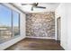 Room featuring an exposed brick accent wall and a large window with nice city views at 2626 Peachtree Nw Rd # 1102, Atlanta, GA 30305