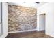 Bedroom with unique brick accent wall and hardwood flooring at 2626 Peachtree Nw Rd # 1102, Atlanta, GA 30305