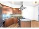 Modern kitchen with stainless steel appliances, granite countertops, and lots of wood cabinetry at 2626 Peachtree Nw Rd # 1102, Atlanta, GA 30305