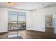 Living room with a door that opens onto a balcony and exposed brick in an adjacent room at 2626 Peachtree Nw Rd # 1102, Atlanta, GA 30305
