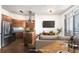 Living area featuring wood floors, kitchen with stainless steel appliances, and a comfortable sofa at 2626 Peachtree Nw Rd # 1102, Atlanta, GA 30305