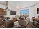 Bright living room with a modern sofa, open to a kitchen with stainless steel appliances and city views at 2626 Peachtree Nw Rd # 1102, Atlanta, GA 30305