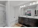 Elegant bathroom featuring double sinks, a soaking tub, and a glass enclosed shower at 5512 Cascade Sw Run, Atlanta, GA 30336