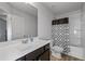 Bright bathroom featuring a modern vanity with a white countertop and a shower-tub combo with a patterned curtain at 5512 Cascade Sw Run, Atlanta, GA 30336