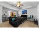 Comfortable bedroom with a ceiling fan, a tray ceiling, and an accent painting above the bed at 5512 Cascade Sw Run, Atlanta, GA 30336