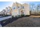 Charming two-story home featuring an attached garage and manicured front yard, with a view of additional homes next door at 5512 Cascade Sw Run, Atlanta, GA 30336