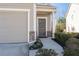 Exterior view showcasing the property's front door, garage, and landscaped yard at 5512 Cascade Sw Run, Atlanta, GA 30336