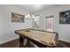 Game room with pool table, modern lighting, and natural light from the door and window at 5512 Cascade Sw Run, Atlanta, GA 30336