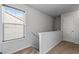 Bright hallway features neutral paint, carpeted floors, and a window with natural light at 5512 Cascade Sw Run, Atlanta, GA 30336