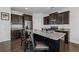 Modern kitchen island with granite countertops, stainless steel appliances, and dark wood cabinetry at 5512 Cascade Sw Run, Atlanta, GA 30336