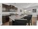 Modern kitchen island with granite countertops, stainless steel appliances, and dark wood cabinetry at 5512 Cascade Sw Run, Atlanta, GA 30336