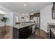 Open kitchen featuring a center island with granite counters, stainless appliances, and dark cabinetry at 5512 Cascade Sw Run, Atlanta, GA 30336