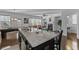 Open-concept living space with a kitchen island, pool table, fireplace, and comfortable seating at 5512 Cascade Sw Run, Atlanta, GA 30336
