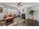 Cozy living room featuring a fireplace, comfortable sofa, and a ceiling fan at 5512 Cascade Sw Run, Atlanta, GA 30336