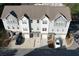 Overhead view of three-story townhomes showing roof lines, driveways, and surrounding landscaping at 951 Plaza Park Walk # 50, Kennesaw, GA 30144