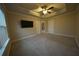 Carpeted bedroom with lighted ceiling fan and TV at 951 Plaza Park Walk # 50, Kennesaw, GA 30144