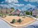 Expansive aerial view of a beautifully landscaped home on a corner lot with a circular driveway at 955 Golf View Ct, Dacula, GA 30019