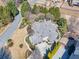 Aerial view of property with lush landscaping, well-maintained lawn, and a circular driveway at 955 Golf View Ct, Dacula, GA 30019